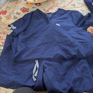 Figs Navy Blue Scrub Set. Aya healthcare travel nurse logo